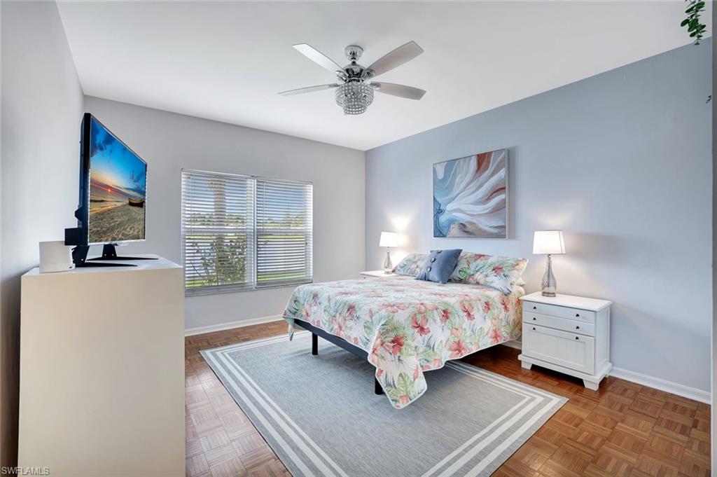 613 Windsor Square, Unit 101 Naples, FL 34104 - Photo 10 of 22 a bedroom with a bed and window