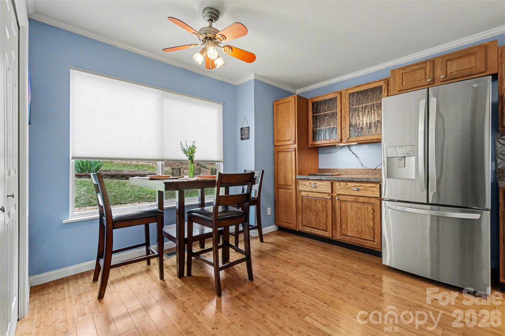 26030 Misty Way Drive Tega Cay, SC 29708 - Photo 11 of 43 a kitchen with a table chairs refrigerator and microwave