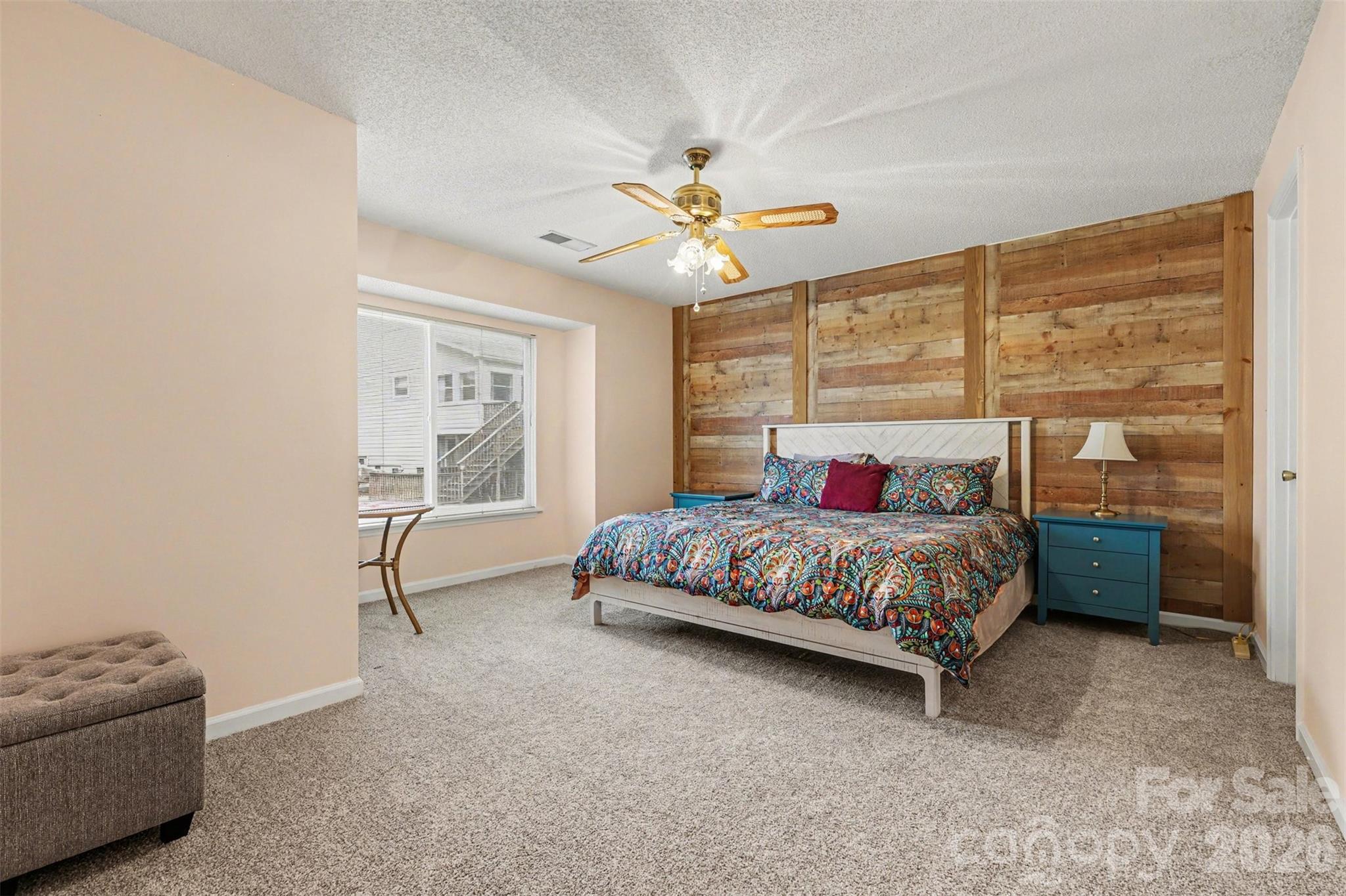 26030 Misty Way Drive Tega Cay, SC 29708 - Photo 15 of 43 a bedroom with a bed a couch and a chandelier