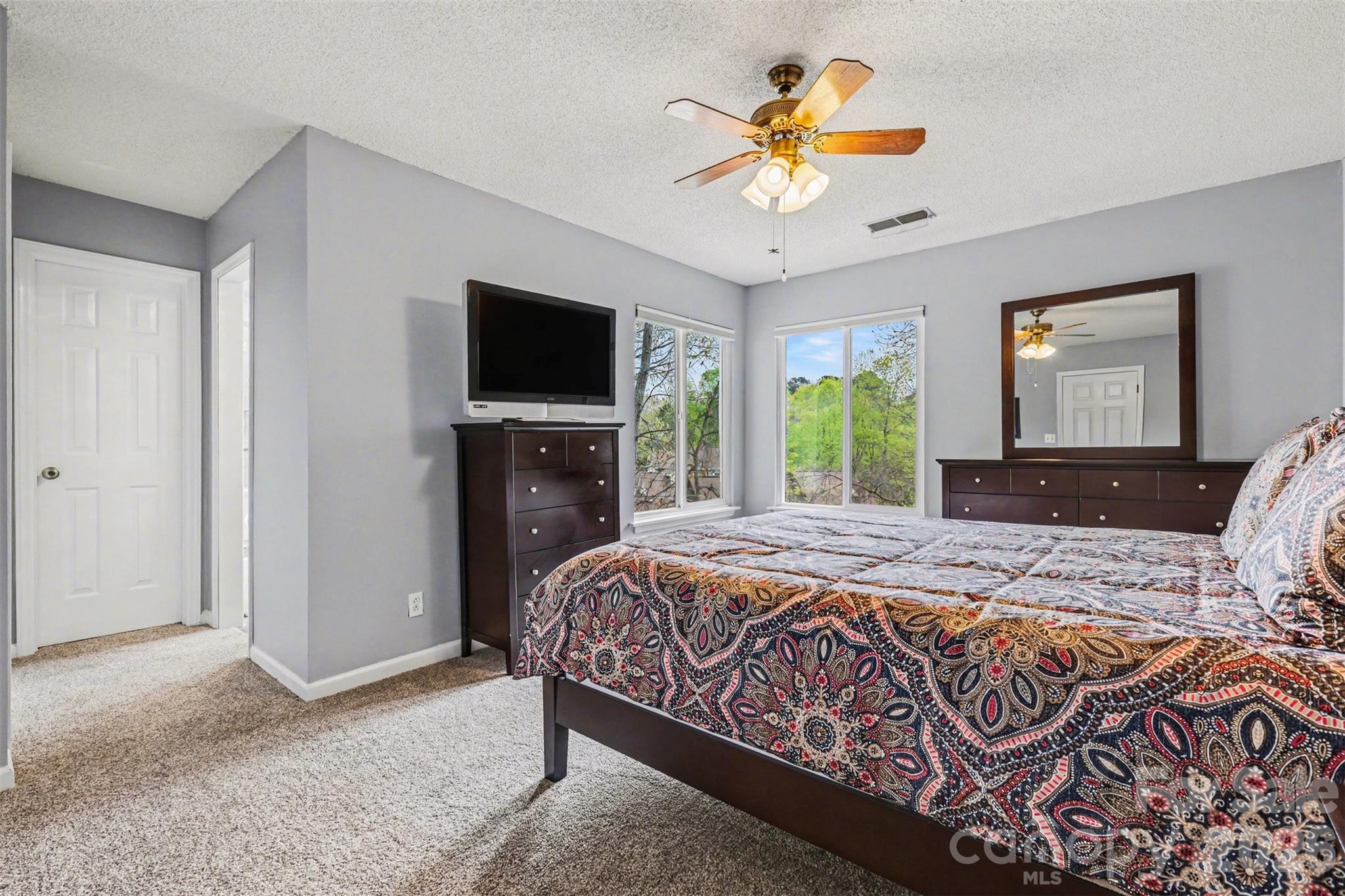 26030 Misty Way Drive Tega Cay, SC 29708 - Photo 20 of 43 a bedroom with a bed and a flat screen tv