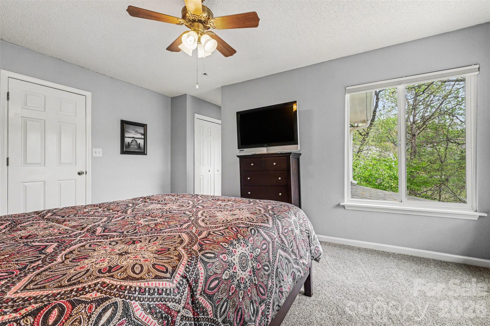 26030 Misty Way Drive Tega Cay, SC 29708 - Photo 21 of 43 a bedroom with a bed and a flat screen tv