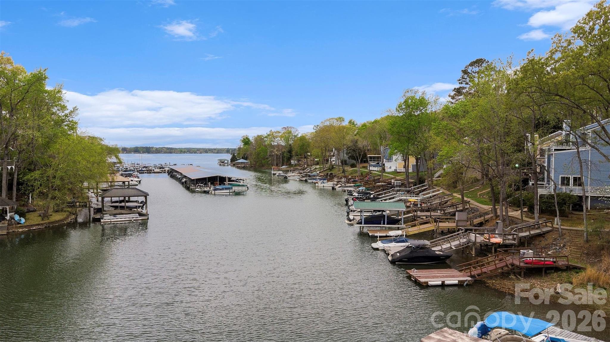 26030 Misty Way Drive Tega Cay, SC 29708 - Photo 37 of 43 a view of water with boats and trees in the background