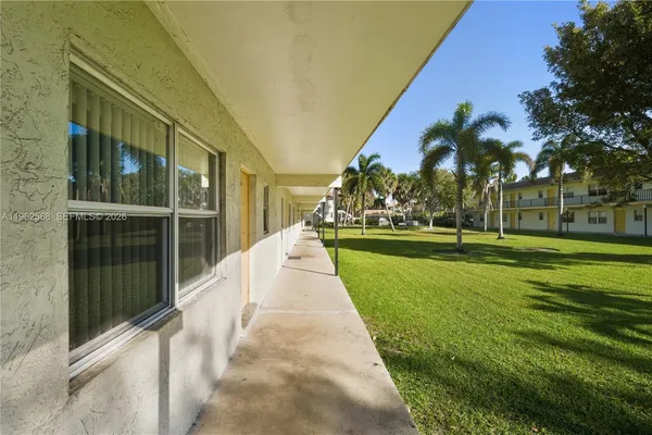 a view of a white house with a street