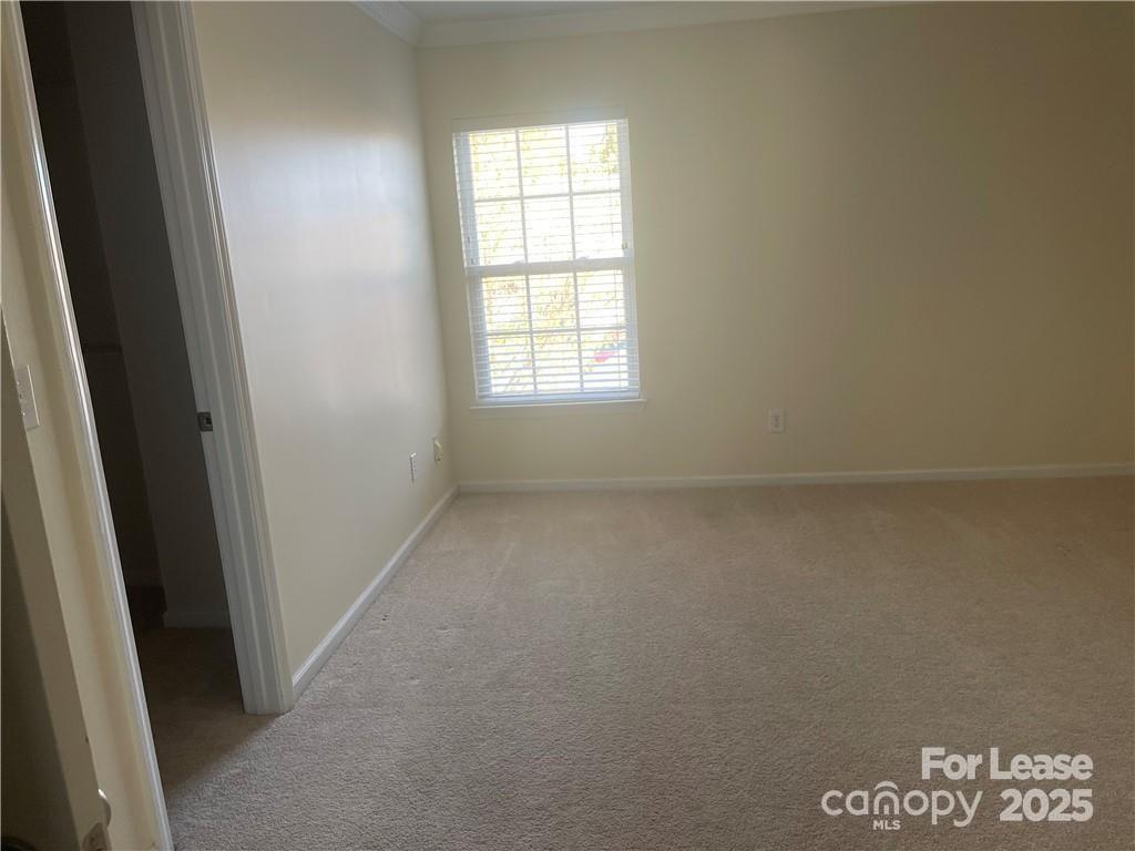 11917 Stratfield Pl Circle, Unit 118 Pineville, NC 28134 - Photo 11 of 28 an empty room with a window