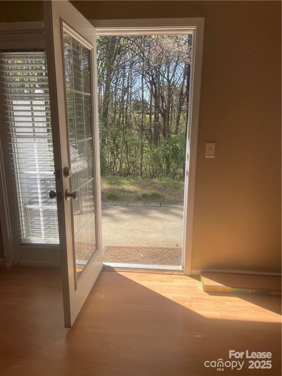 11917 Stratfield Pl Circle, Unit 118 Pineville, NC 28134 - Photo 25 of 28 a view of empty room with wooden floor and a window
