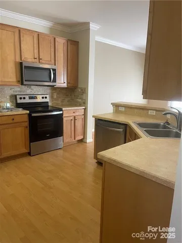 a kitchen with a sink and a stove top oven