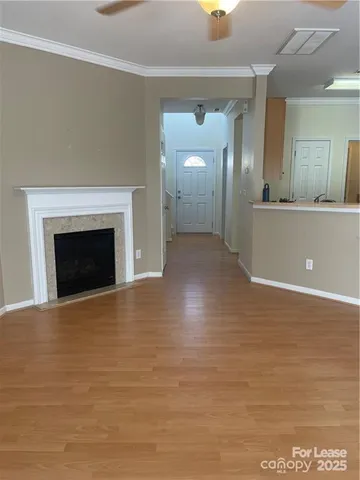 a view of empty room with wooden floor