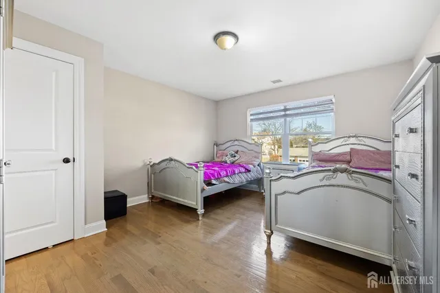 a bedroom with bed and a window