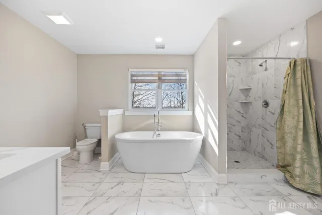 a spacious bathroom with a bathtub and shower