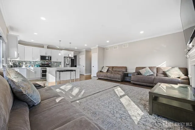 a living room with furniture and kitchen view