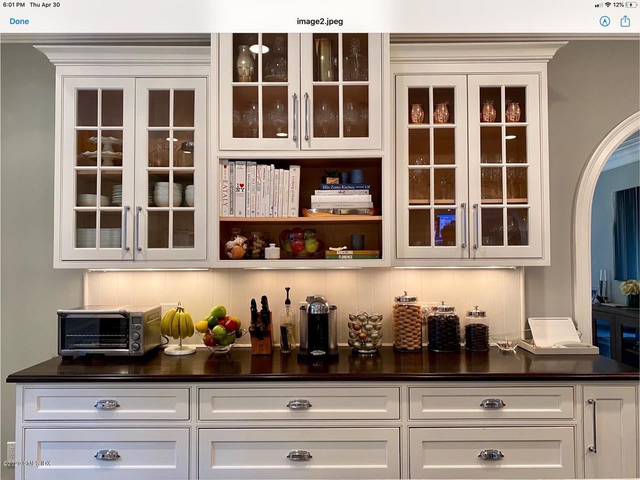 1 Club Road Riverside, CT 06878 - Photo 16 of 37 a front view of a house with potted plants