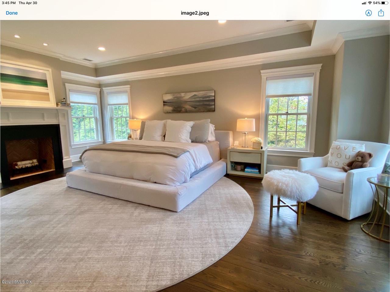 1 Club Road Riverside, CT 06878 - Photo 19 of 37 a spacious bedroom with a bed and a couch