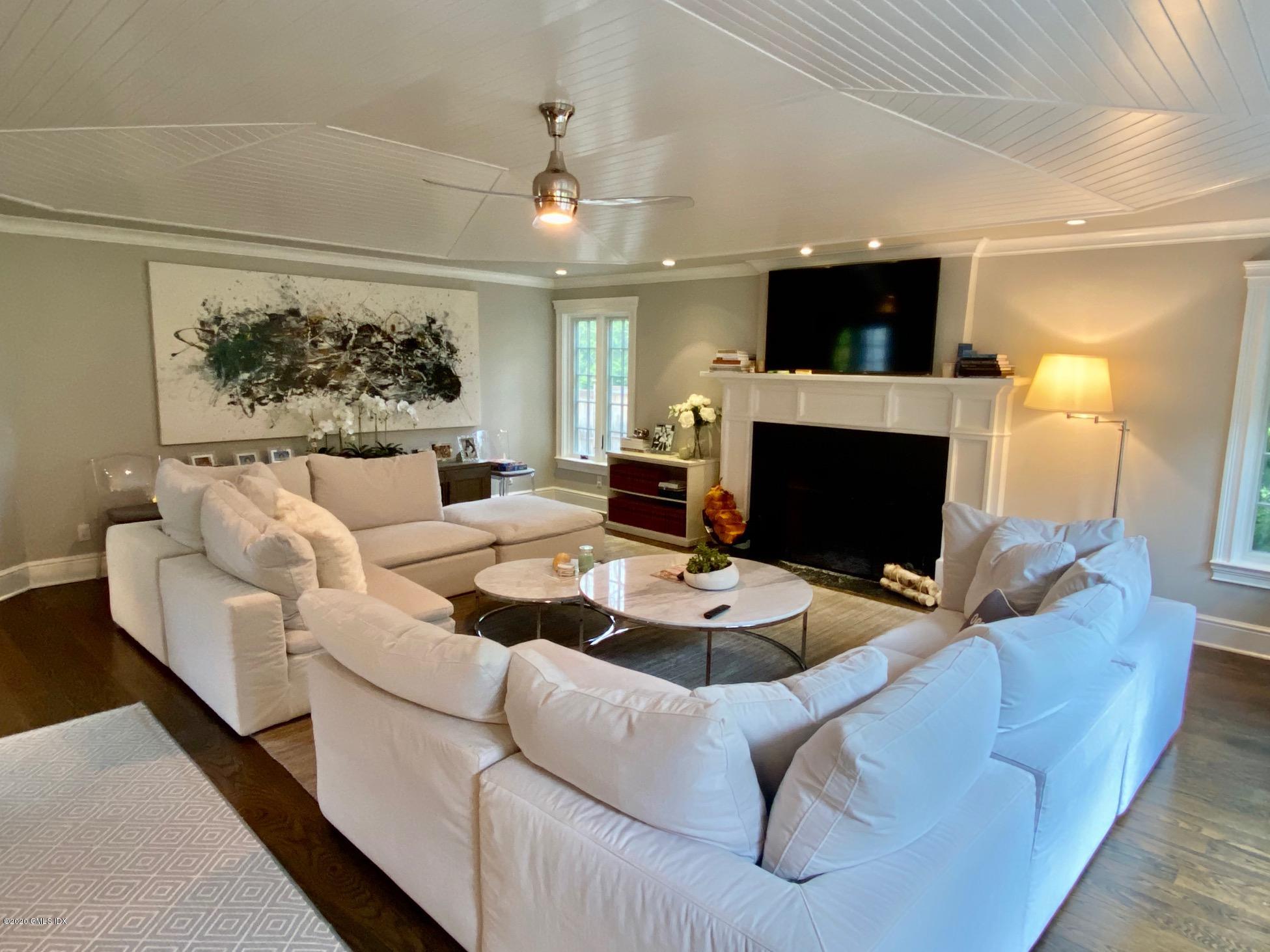 1 Club Road Riverside, CT 06878 - Photo 10 of 37 a living room with furniture a flat screen tv and a fireplace