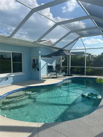 a swimming pool with outdoor seating and yard