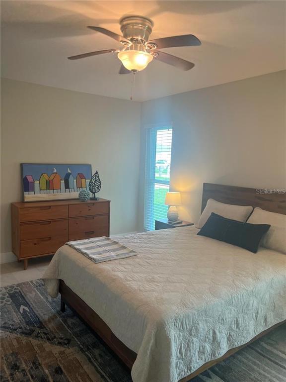 118 Caddy Road Rotonda West, FL 33947 - Photo 8 of 10 a bedroom with a bed and window
