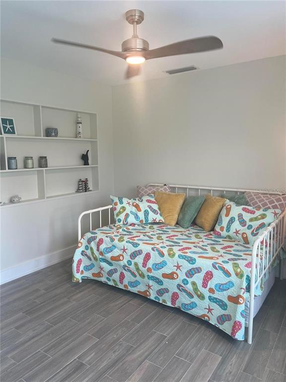 118 Caddy Road Rotonda West, FL 33947 - Photo 9 of 10 a bedroom with a bed that has a blanket on it