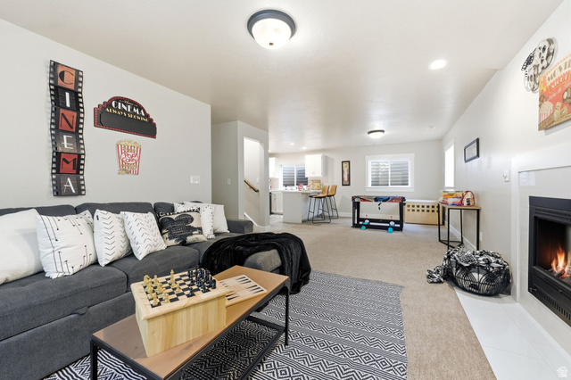 1405 Vintry Lane Murray, UT 84121 - Photo 25 of 44 Spacious living area featuring neutral carpeting, a built-in fireplace with a white mantel, and recessed lighting