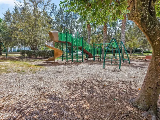 an aerial view of a house with a yard and lake view