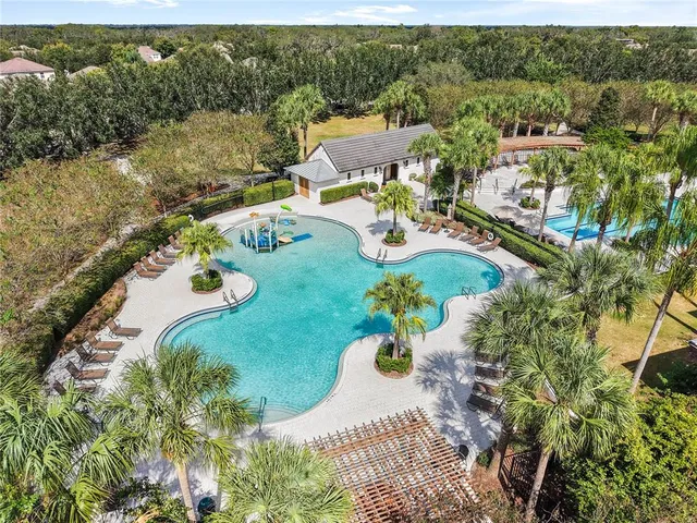 an aerial view of a house with yard swimming pool and outdoor seating