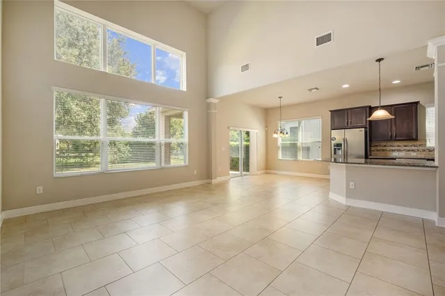 a view of large kitchen with stainless steel appliances kitchen island granite countertop a stove a sink a microwave and a refrigerator