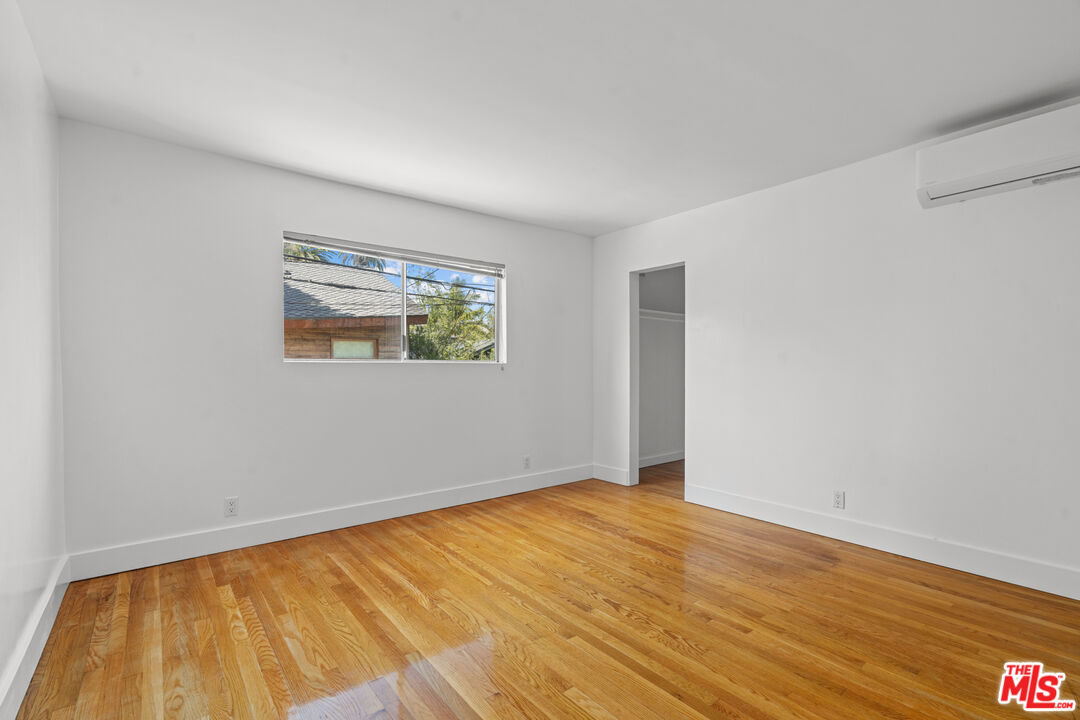 511 Rialto Avenue, Unit 4 Venice, CA 90291 - Photo 14 of 17 a view of an empty room with wooden floor and a window