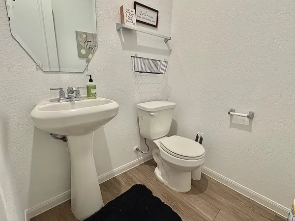 a bathroom with a sink toilet and a mirror
