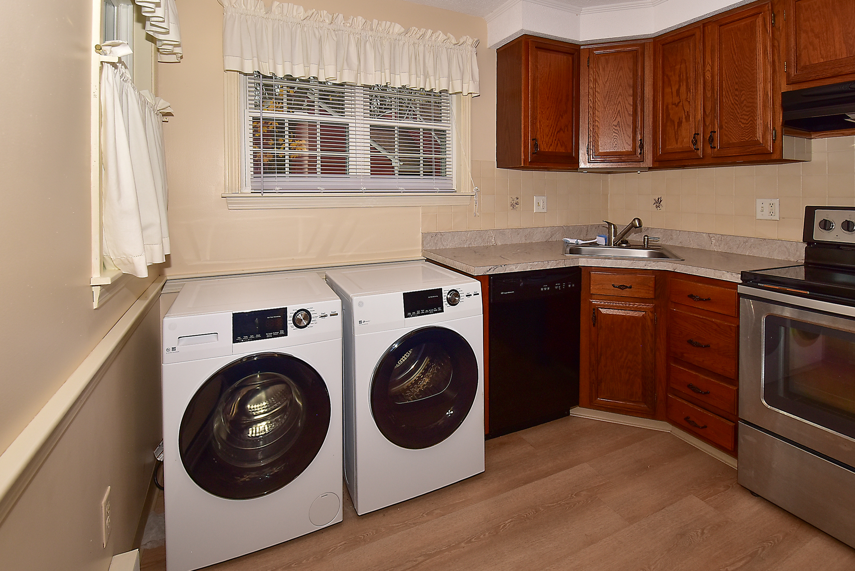 413 Lady Bug Lane, Unit 413 Vernon, CT 06066 - Photo 12 of 28 a utility room with sink dryer and washer