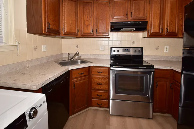 a utility room with sink dryer and washer