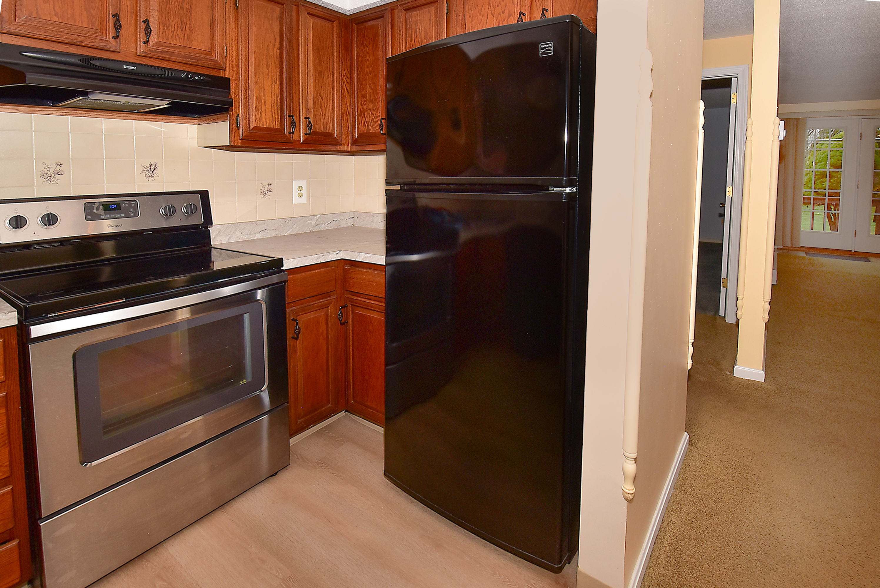 413 Lady Bug Lane, Unit 413 Vernon, CT 06066 - Photo 14 of 28 a kitchen with a refrigerator and a stove top oven