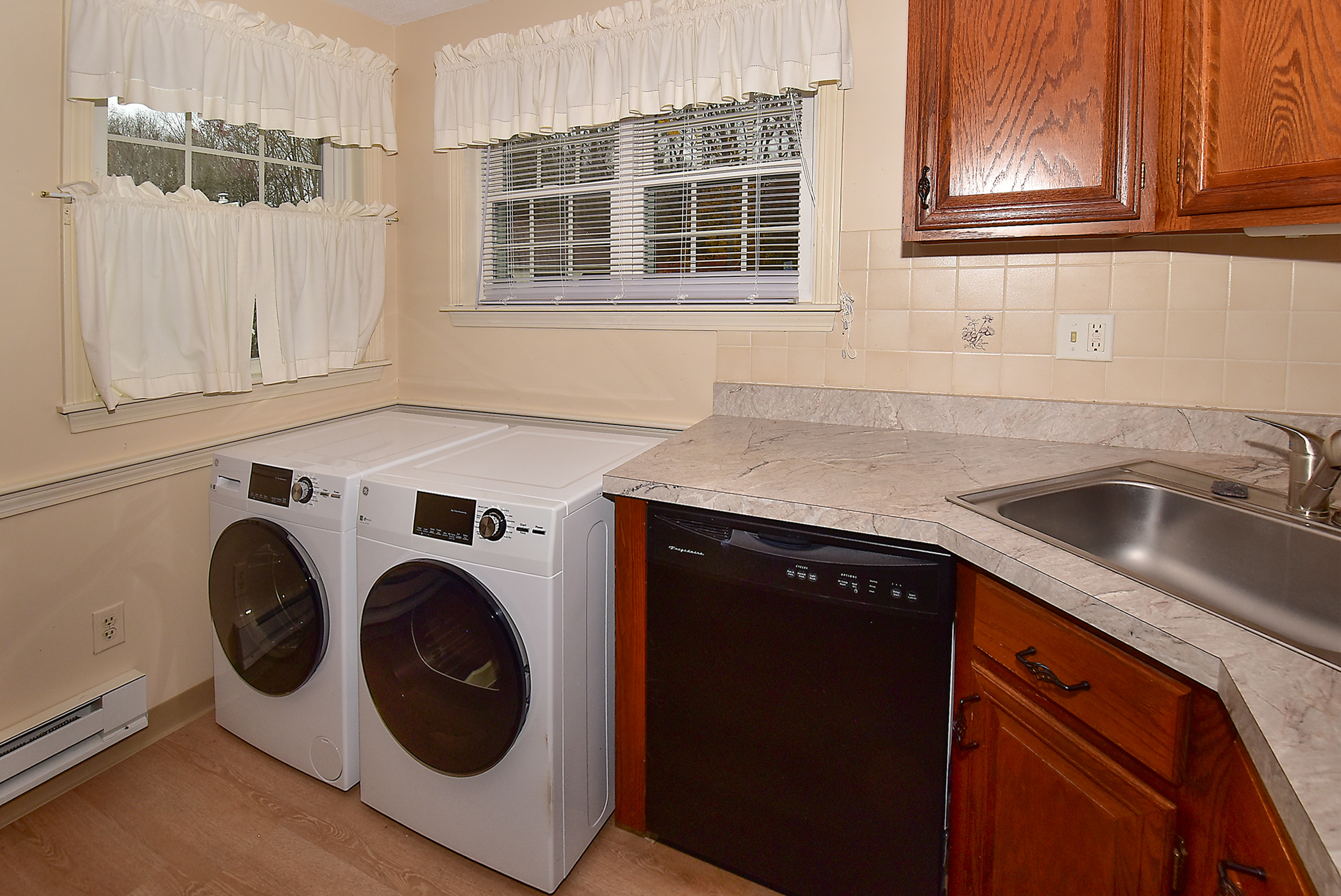 413 Lady Bug Lane, Unit 413 Vernon, CT 06066 - Photo 15 of 28 a utility room with sink dryer and washer