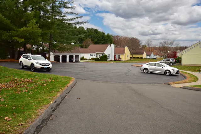 a car parked in front of white house