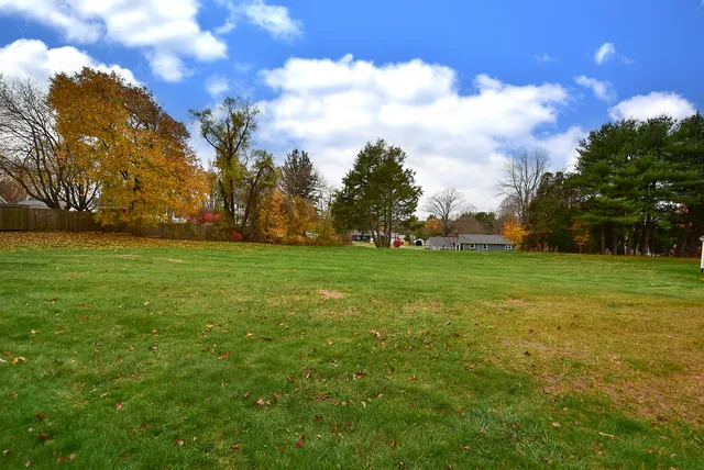 a front view of a house with a garden and yard