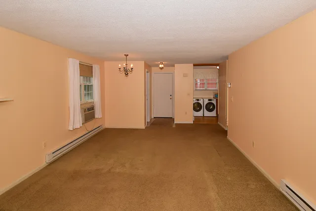 a view of a hallway with an empty room and closet