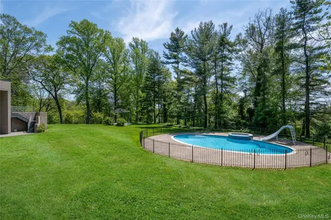 a view of a house with backyard sitting area and garden