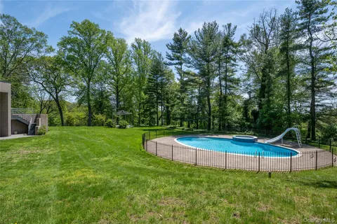 a aerial view of a house with backyard space and a fountain