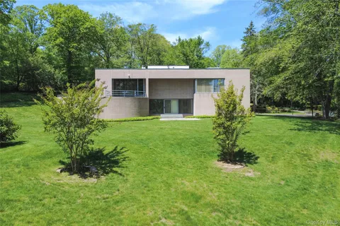 an aerial view of a house with swimming pool and garden view