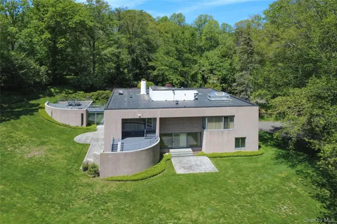 an aerial view of a house with a yard and trees