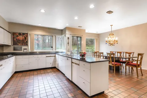 a kitchen with granite countertop a sink and cabinets