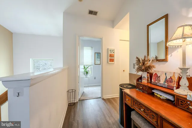a bedroom with furniture and a wooden floor