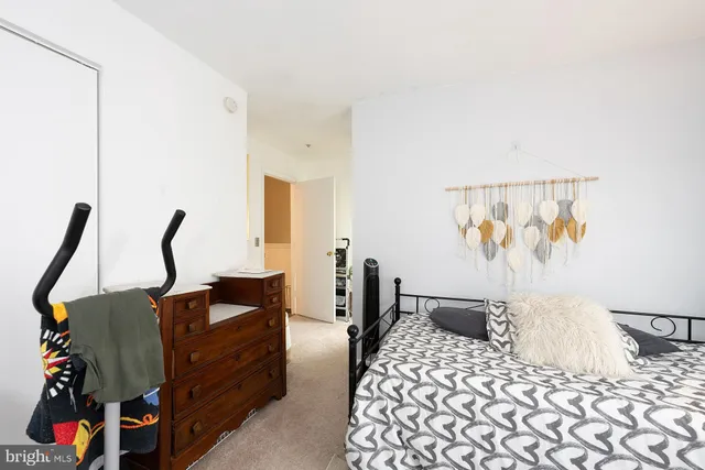 a view of a hallway with bathroom and wooden floor