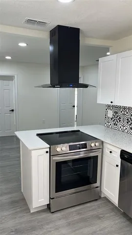 a stove top oven sitting inside of a kitchen