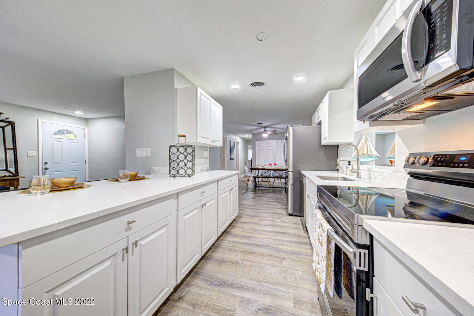 758 Buffalo Road Titusville, FL 32796 - Photo 18 of 52 a kitchen with counter top space stainless steel appliances and cabinets