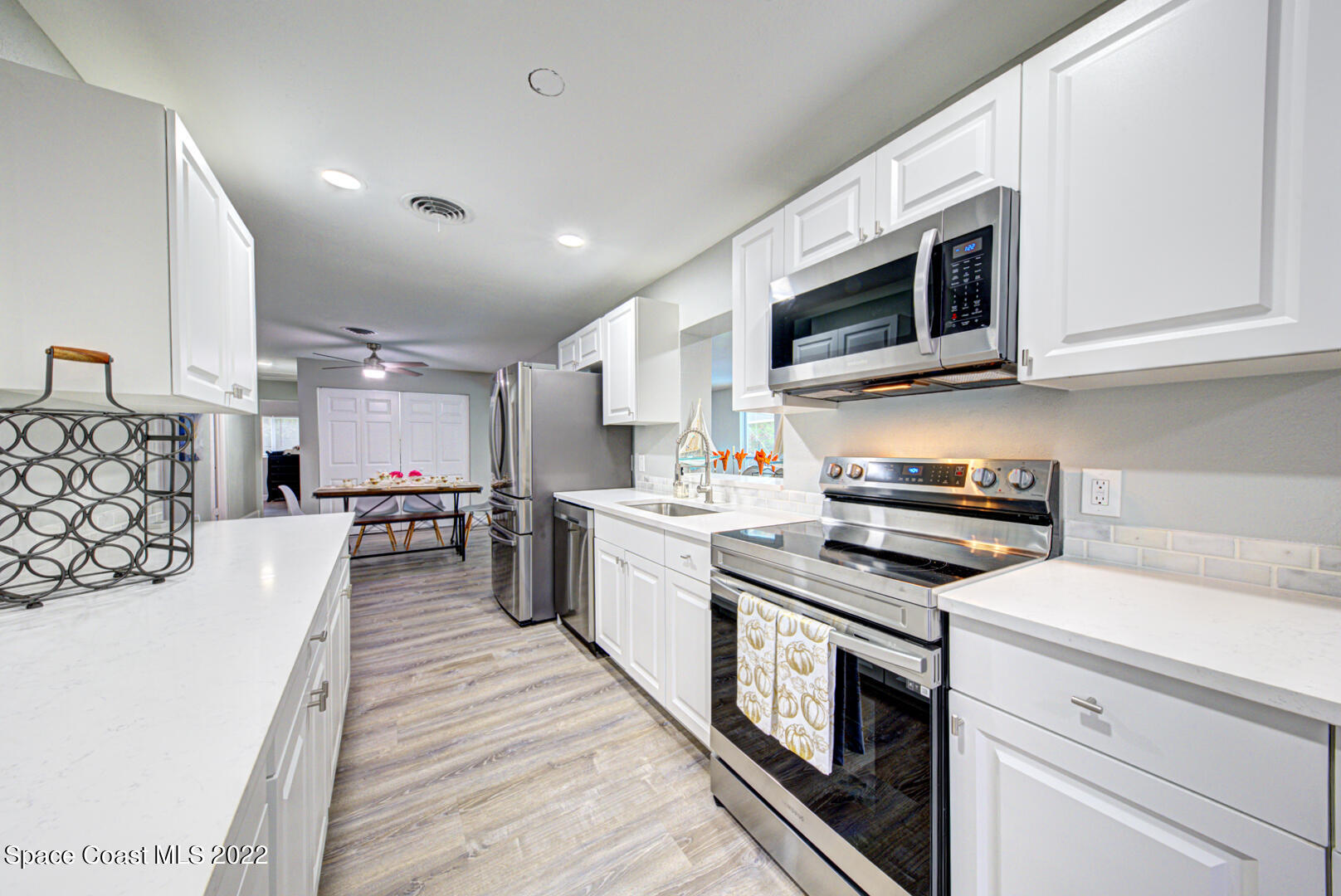 758 Buffalo Road Titusville, FL 32796 - Photo 19 of 52 a kitchen with stainless steel appliances granite countertop a stove and a microwave