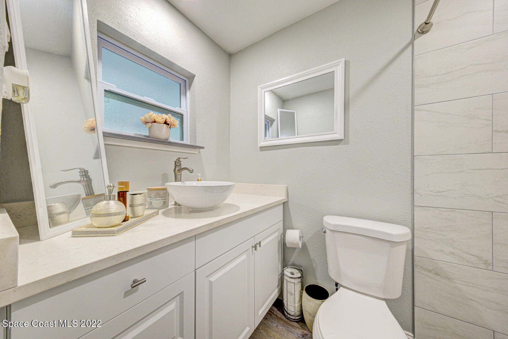 758 Buffalo Road Titusville, FL 32796 - Photo 27 of 52 a bathroom with a toilet a sink and mirror