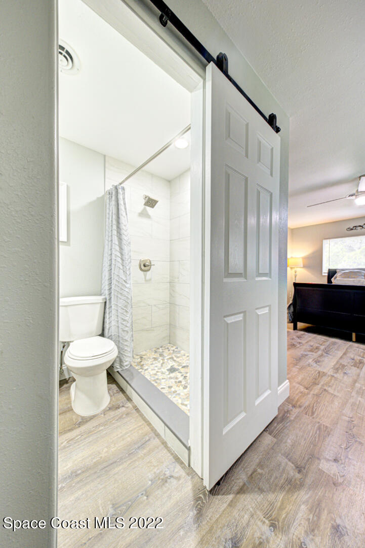 758 Buffalo Road Titusville, FL 32796 - Photo 29 of 52 a bathroom with a glass shower door