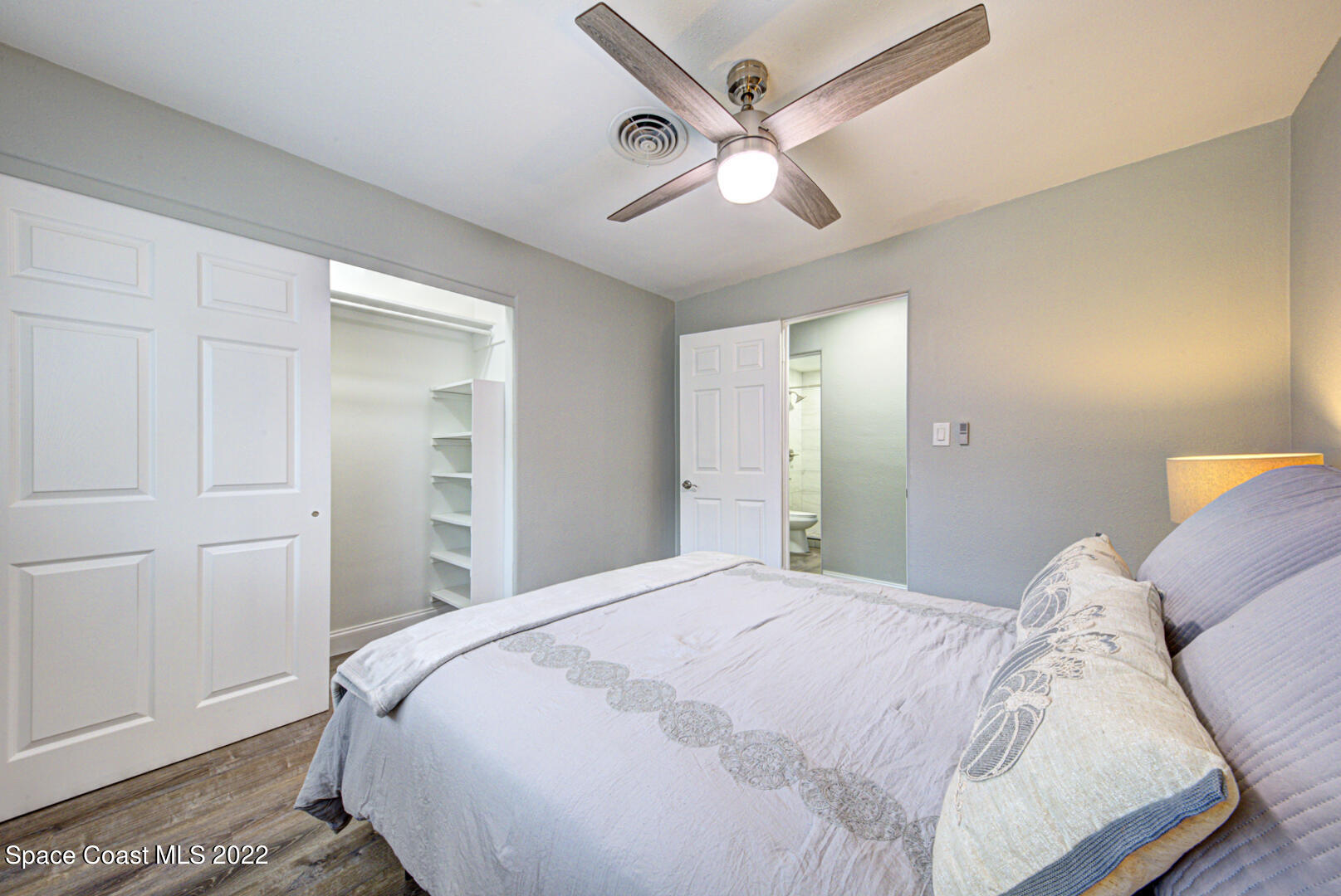 758 Buffalo Road Titusville, FL 32796 - Photo 32 of 52 a bedroom with a large bed and a chandelier