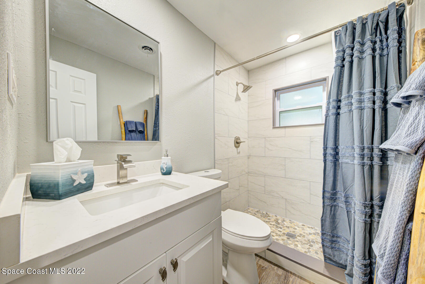 758 Buffalo Road Titusville, FL 32796 - Photo 33 of 52 a bathroom with a double vanity sink toilet and shower