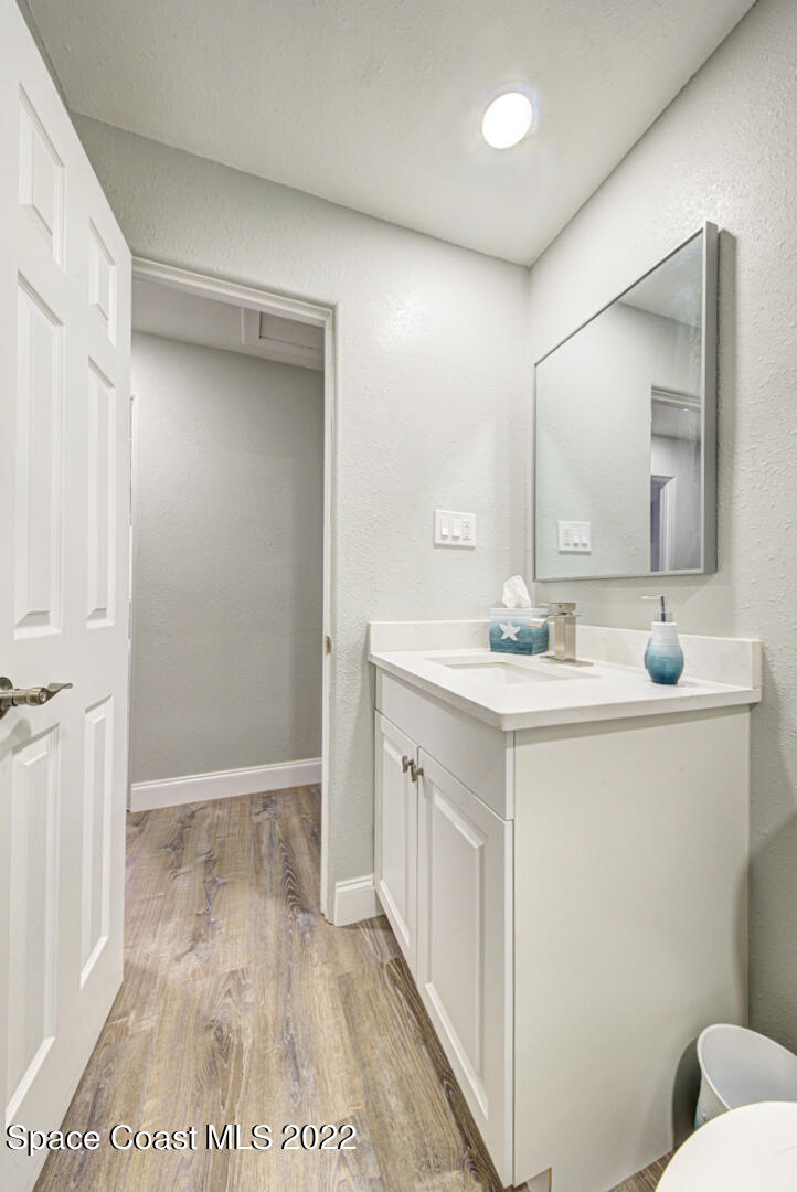 758 Buffalo Road Titusville, FL 32796 - Photo 34 of 52 a bathroom with a sink a mirror and a toilet