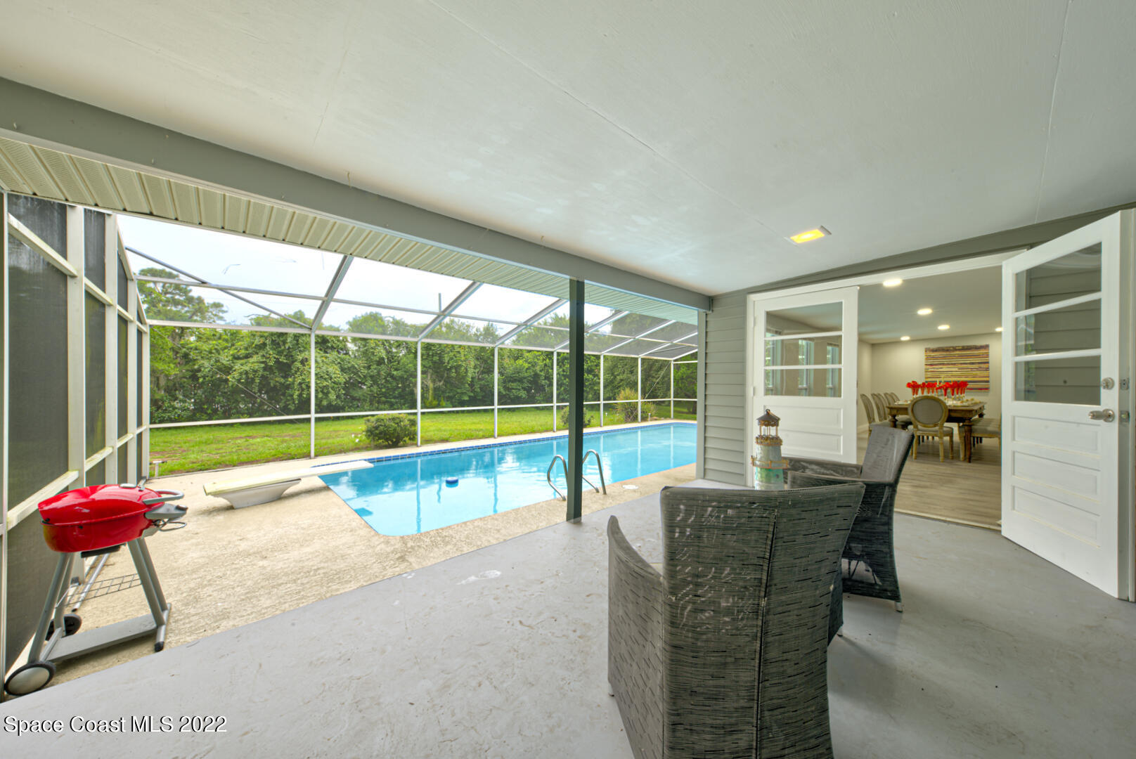 758 Buffalo Road Titusville, FL 32796 - Photo 40 of 52 a swimming pool with outdoor seating and yard