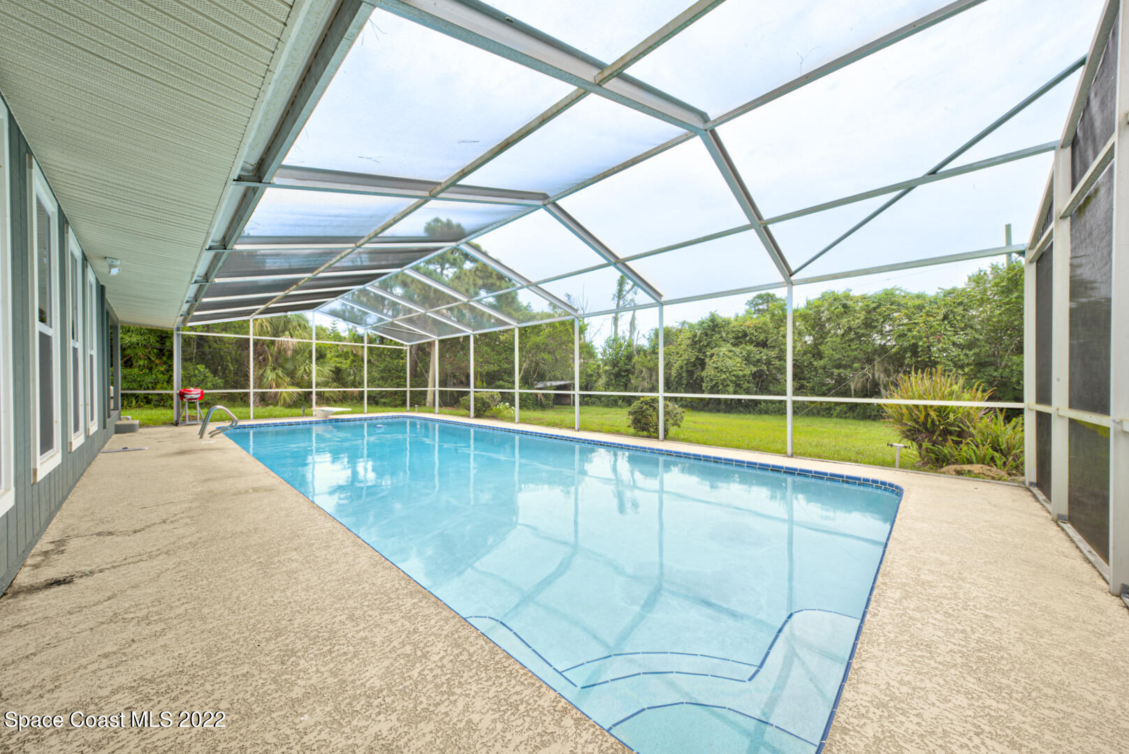 758 Buffalo Road Titusville, FL 32796 - Photo 41 of 52 a view of a swimming pool with a porch